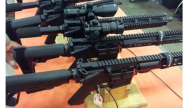 Row of pistols on stands attached to accessories.